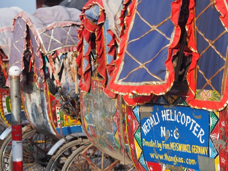 A row of bicycle rickshaws