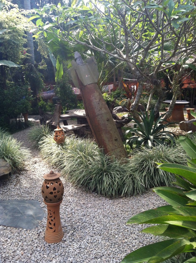 A bar rather poignantly decorates the garden &nbsp;in debris left over from the war