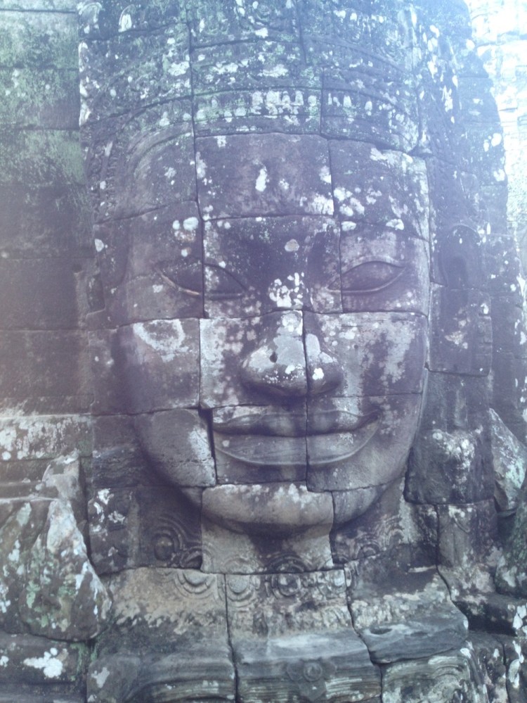 One of the many stone faces at Bayon - with more of a smile on her face than our children!
