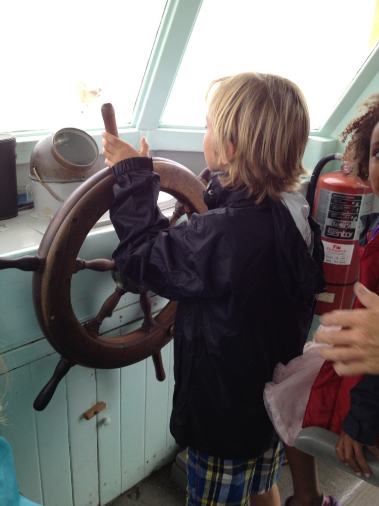 Gabriel takes the hele on the boat from Russell