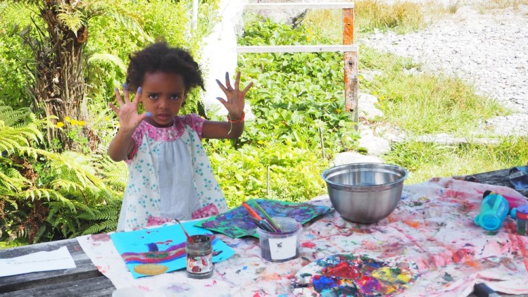 Amelia and MIllie paint together in the garden