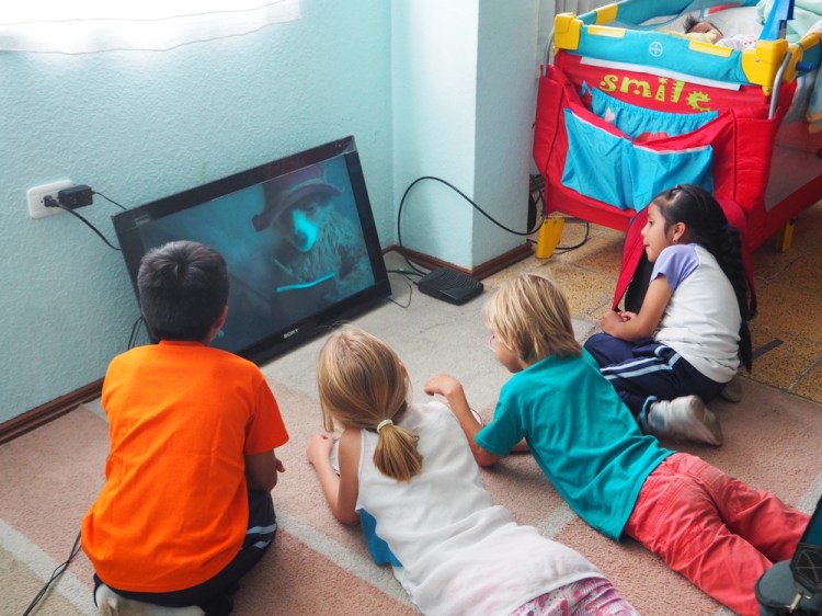 The kids watch Paddington on the tv