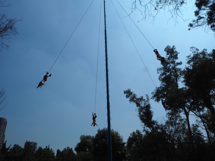 This is not the best picture but it is some men hanging down from a pole tied to a rope on their ankles